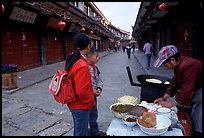 Schoolchildren get Naxi flatbread for breakfast. Lijiang, Yunnan, China ( color)