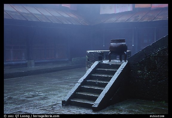 Urn and stairs in courtyard of Xiangfeng temple in fog. Emei Shan, Sichuan, China (color)