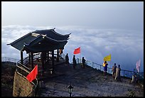 Monks and pilgrims admiring a sea of cloud from the summit. Emei Shan, Sichuan, China ( color)