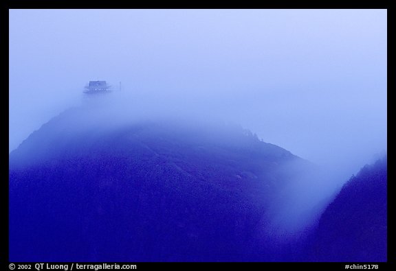 Fog sweaps over Wanfo Ding (Ten Thousand Buddhas Summit) at dusk. Emei Shan, Sichuan, China (color)