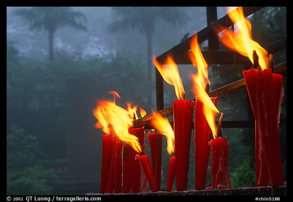 Candles burning with foggy trees in the background, Wannian Si. Emei Shan, Sichuan, China (color)