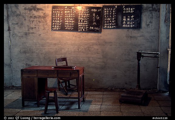 Desk with counting frame, blackboard with Chinese script, scale. Emei Shan, Sichuan, China (color)