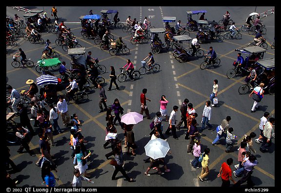 Pedestrians and bicyclists cross a major avenue. Chengdu, Sichuan, China