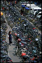 Woman walking in a bicycle parking lot. Chengdu, Sichuan, China ( color)