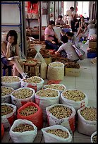 Woman selling dried food items inside the Qingping market. Guangzhou, Guangdong, China (color)