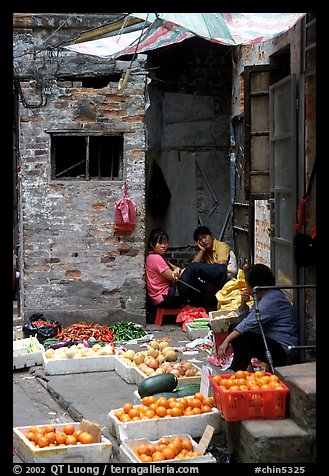 Fruit vendors in a narrow alley. Guangzhou, Guangdong, China