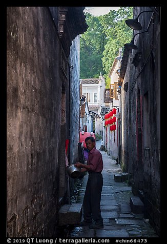 Man using stream water in alley. Hongcun Village, Anhui, China (color)