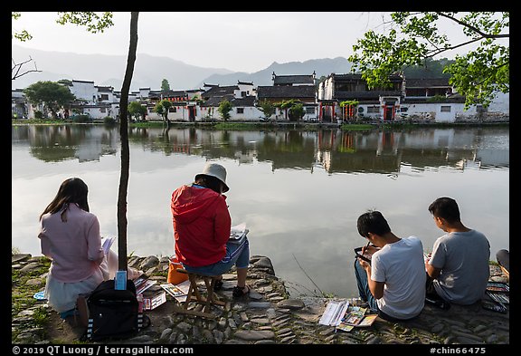 Art students painting along South Lake. Hongcun Village, Anhui, China