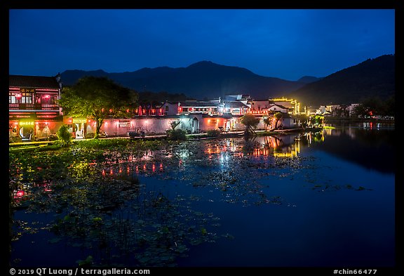 Hongcun village reflected in South Lake at night. Hongcun Village, Anhui, China