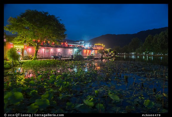 Houses reflected in South Lake at night. Hongcun Village, Anhui, China