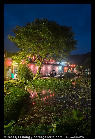 Houses reflected in Nanhu Lake at night. Hongcun Village, Anhui, China