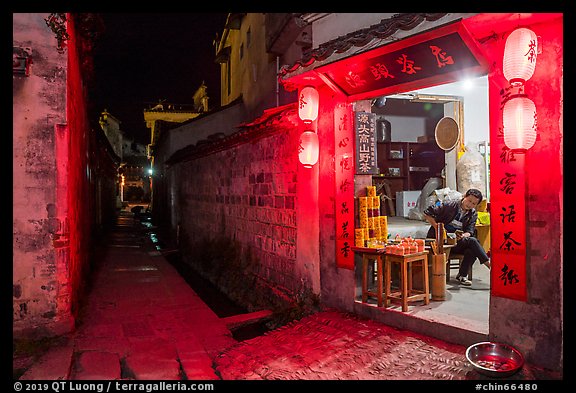 Shopkeeper and alley at night. Hongcun Village, Anhui, China (color)