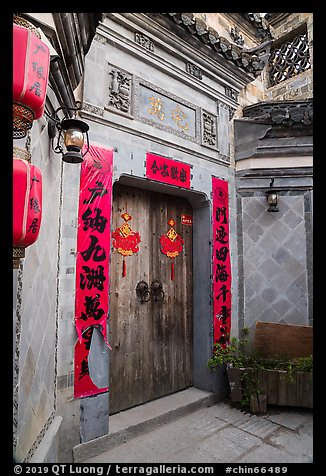 Door with red caligraphed banners. Hongcun Village, Anhui, China