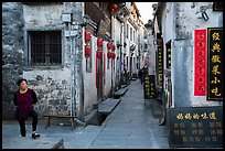 Woman standing next to main street. Xidi Village, Anhui, China ( color)