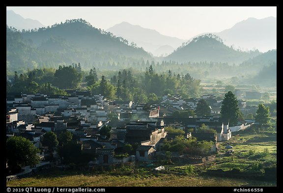 Village and hills in morning fog. Xidi Village, Anhui, China (color)