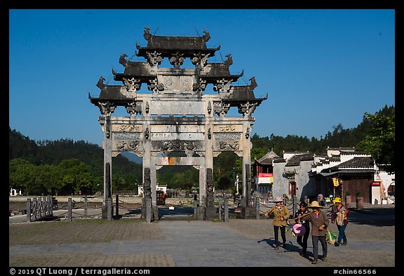 Villagers heading towrds fields, and Hu Wenguang Memorial Arch. Xidi Village, Anhui, China (color)