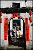 Man with garlic braids hung to dry. Xidi Village, Anhui, China ( color)