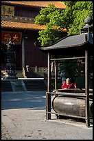 Woman at incense urn, Jingci Temple. Hangzhou, China ( color)