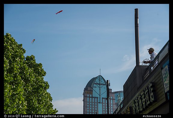 Man flying kite, the Bund. Shanghai, China (color)