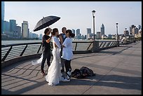 Bride and groom setting up for photos, the Bund. Shanghai, China ( color)