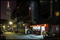 Dark street, store with lanters, and Taipei 101. Taipei, Taiwan (color)