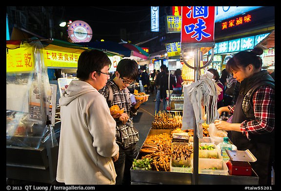 Customer buying foods at Shilin Night Market. Taipei, Taiwan