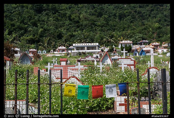 Prayer flags and graves on hillside, Chongde. Taiwan