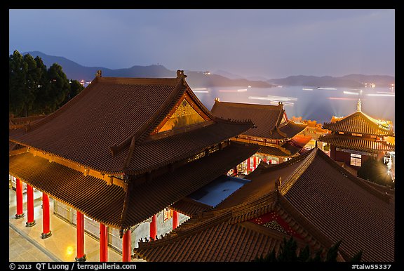 Wen Wu temple at night with light trails from boats. Sun Moon Lake, Taiwan (color)