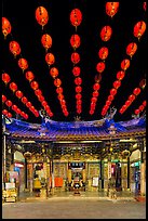 Array of red paper lanterns and temple at night. Lukang, Taiwan (color)