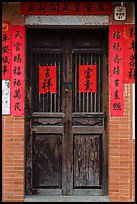 Wooden door with chinese writing on red paper. Lukang, Taiwan ( color)