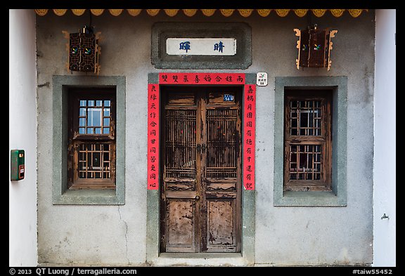 Facade of concrete building with wooden doors and windows. Lukang, Taiwan
