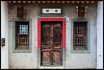 Facade of concrete building with wooden doors and windows. Lukang, Taiwan ( color)