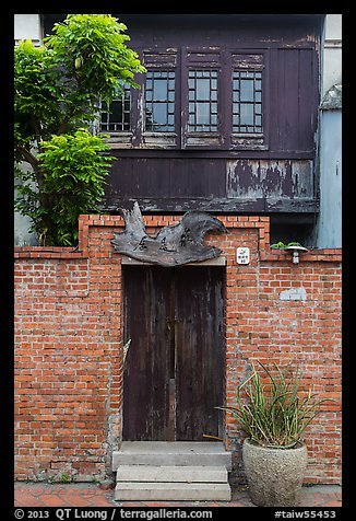 Brick wall and historic wooden house. Lukang, Taiwan