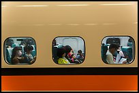 High speed rail car passengers seen through windows. Taiwan (color)