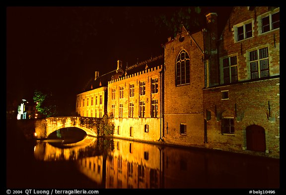 Bridge and houses reflected in canal at night. Bruges, Belgium