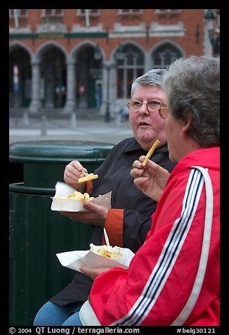 Elderly women eating fries. Bruges, Belgium