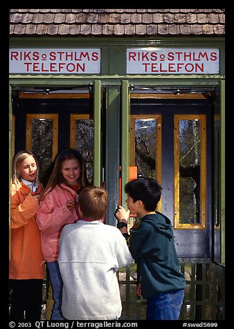 Swedish kids in a phone booth. Stockholm, Sweden (color)