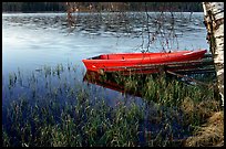 Red boat on a lakeshore. Central Sweden