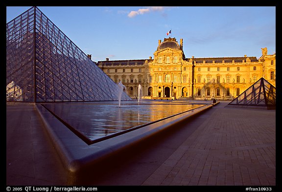 Pyramid, basins, and Sully Wing  in the Louvre, sunset. Paris, France