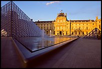 Pyramid, basins, and Sully Wing  in the Louvre, sunset. Paris, France (color)