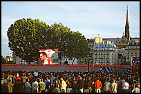 Crowds watch a broadcast of a soccer match near Hotel de Ville. Paris, France (color)