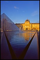 Pyramid and triangular basin in the Louvre, sunset. Paris, France (color)
