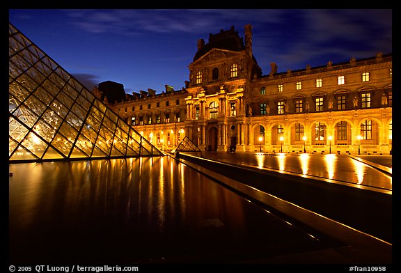 Basin, Pyramid, and Louvre at dusk. Paris, France