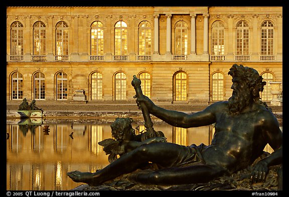 Statue, basin, and facade, late afternoon, Versailles Palace. France (color)