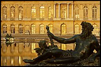 Statue, basin, and facade, late afternoon, Versailles Palace. France