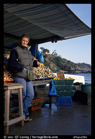 Oyster stand and vendor in Cancale. Brittany, France (color)