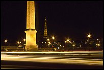 Car lights,  obelisk, and Eiffel Tower at night. Paris, France (color)