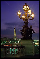 Lamps on Pont Alexandre III and Eiffel Tower at night. Paris, France