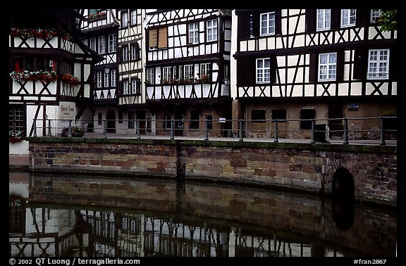 Half-timbered houses reflected in canal. Strasbourg, Alsace, France (color)
