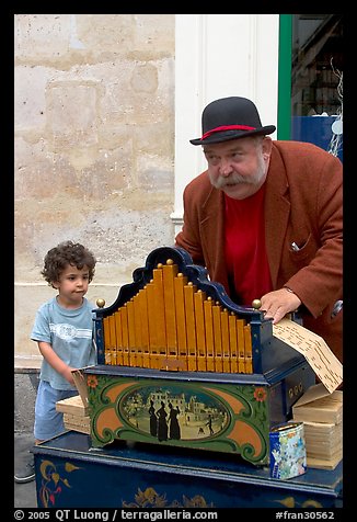 Barrel organ player and kid. Quartier Latin, Paris, France